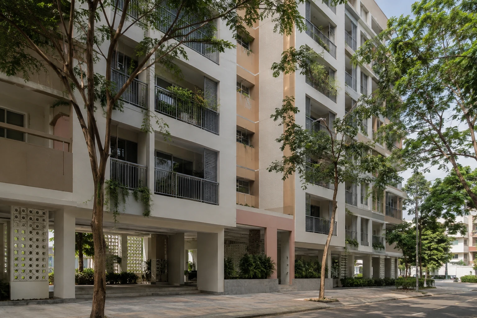 Innerstädtisches Wohngebäude mit tiefen Balkonen und großen tropischen Bäumen in Binh Thanh